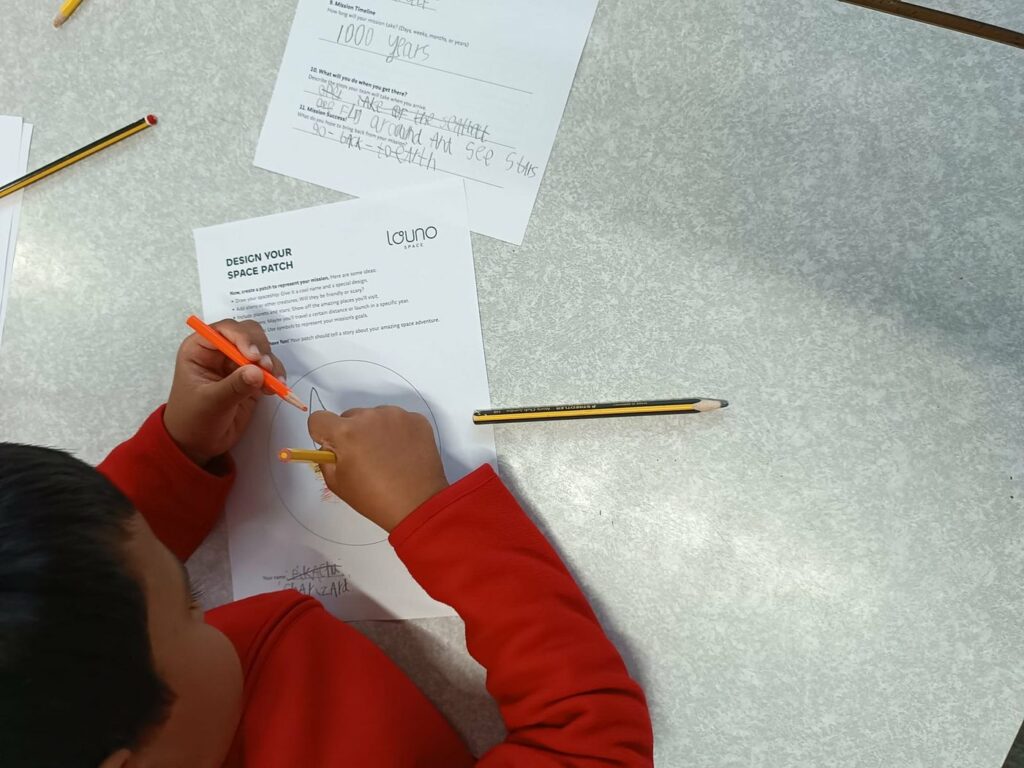 A child filling in a Louno Space mission worksheet