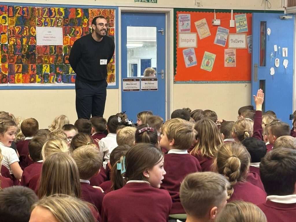 A whole school sitting in the hall for a Louno Space assembly
