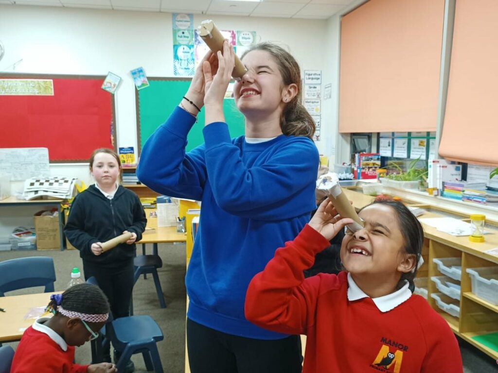 A Mission Specialist demonstrating with mission hardware in a classroom