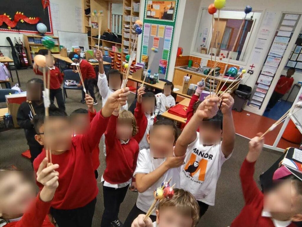 Children holding up the models they are taking home