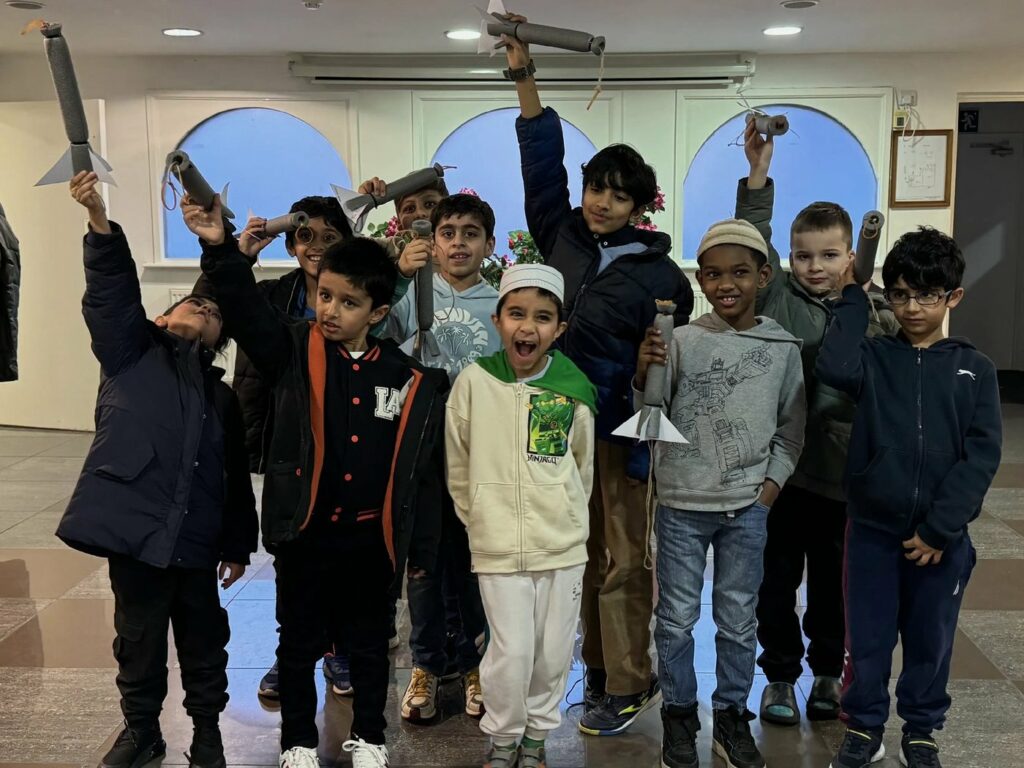 Children holding their finished rockets in the air