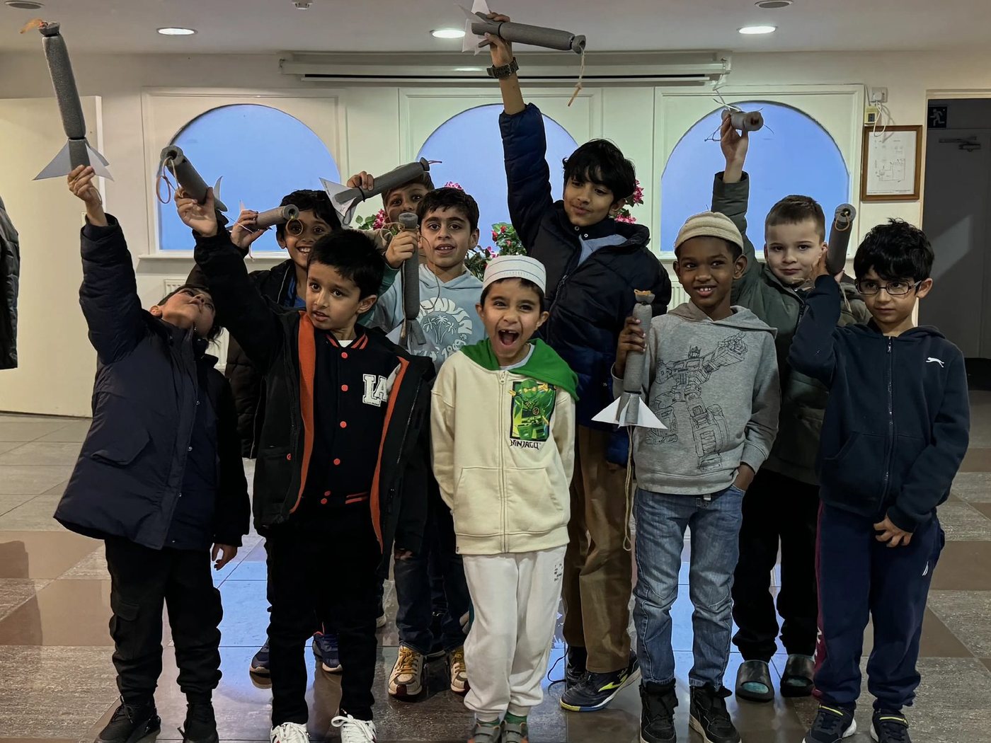 Blog Children holding their finished rockets in the air